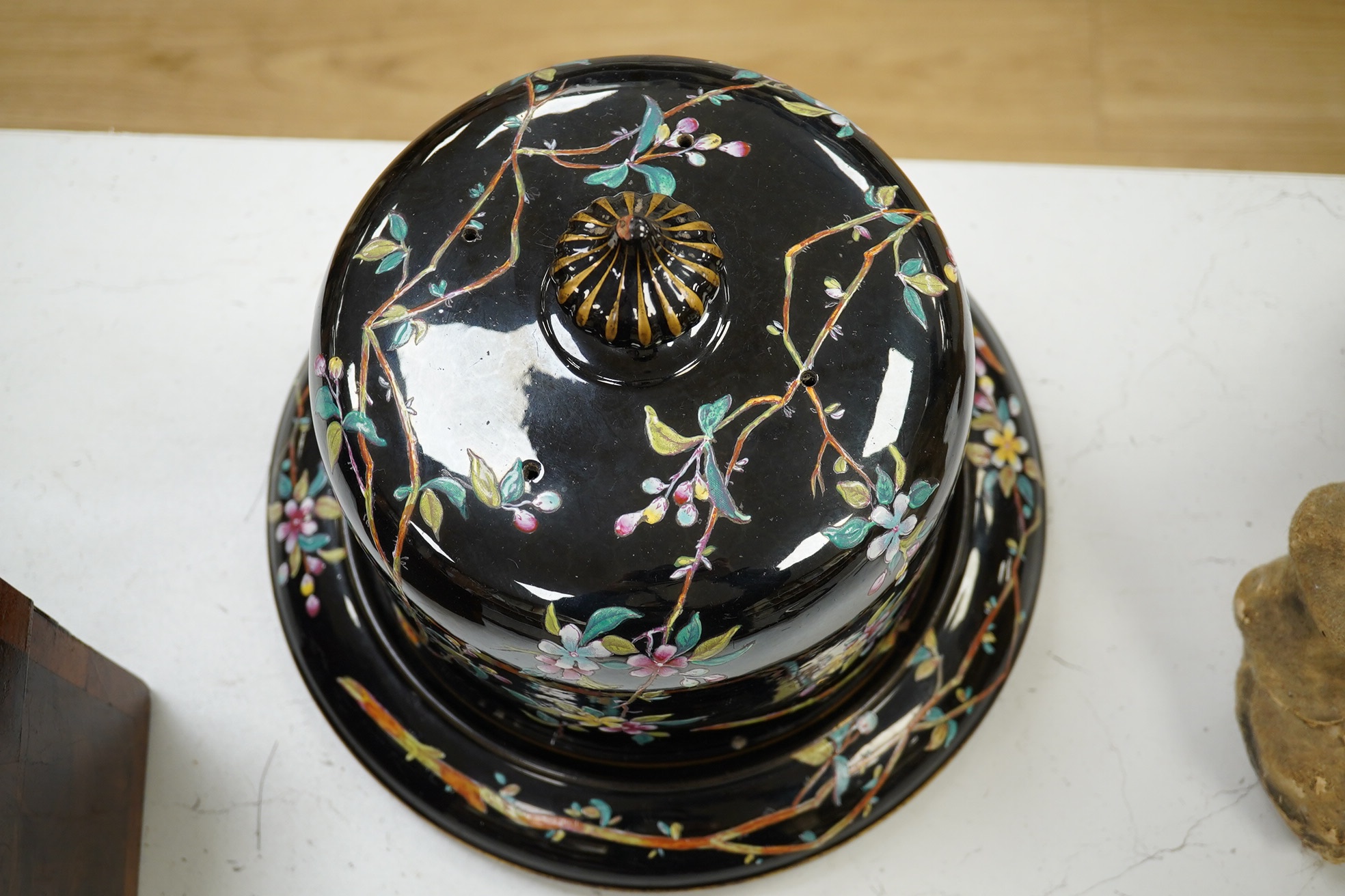 A Victorian cheese dome and stand, black ground with floral decoration, 22cm high. Condition - fair to good